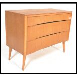 A vintage retro mid 20th Century teak wood Beehive fronted chest of drawers having a bank of three