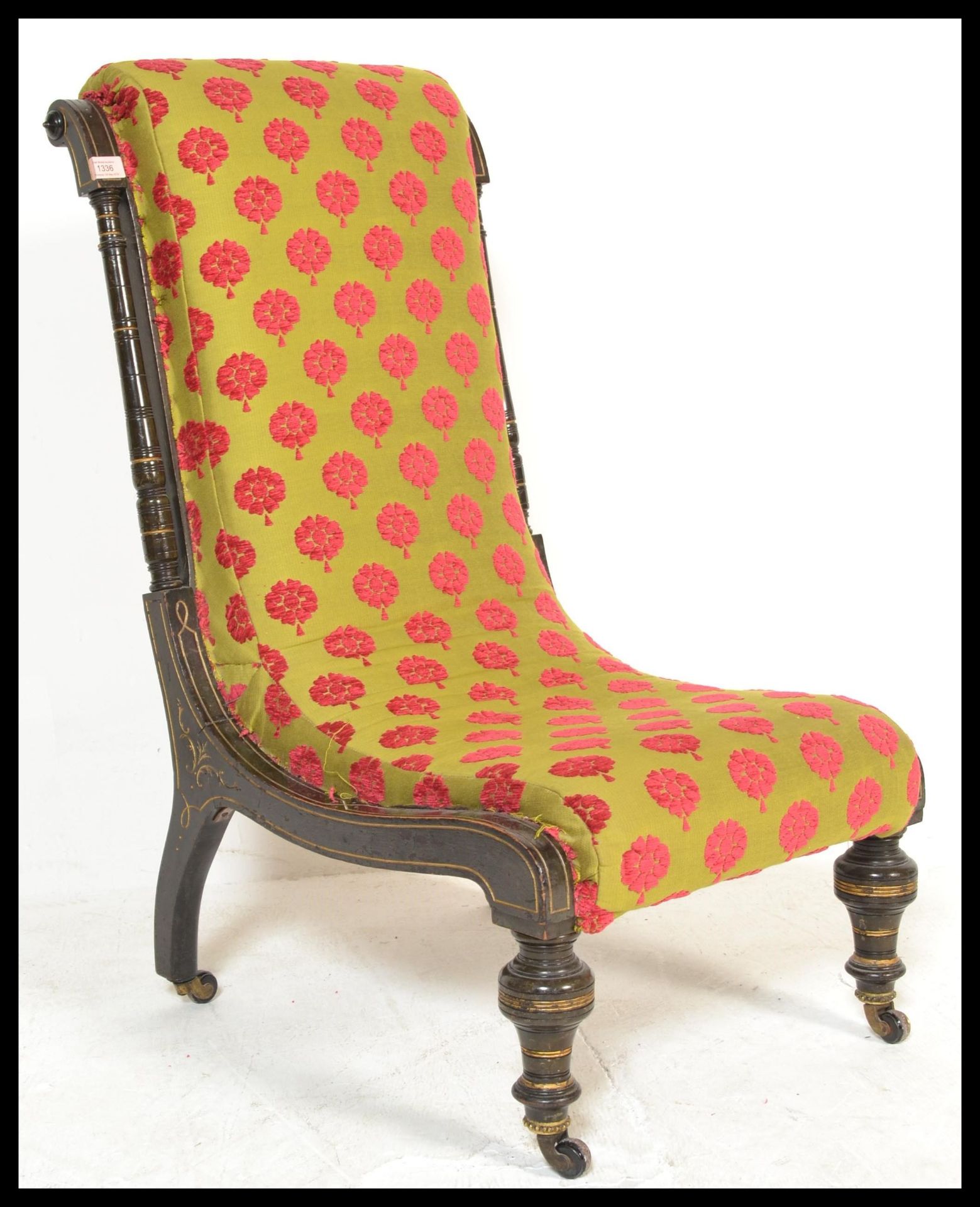A 19th Century Victorian aesthetic movement nursing chair the wooden frame having decorative inlay