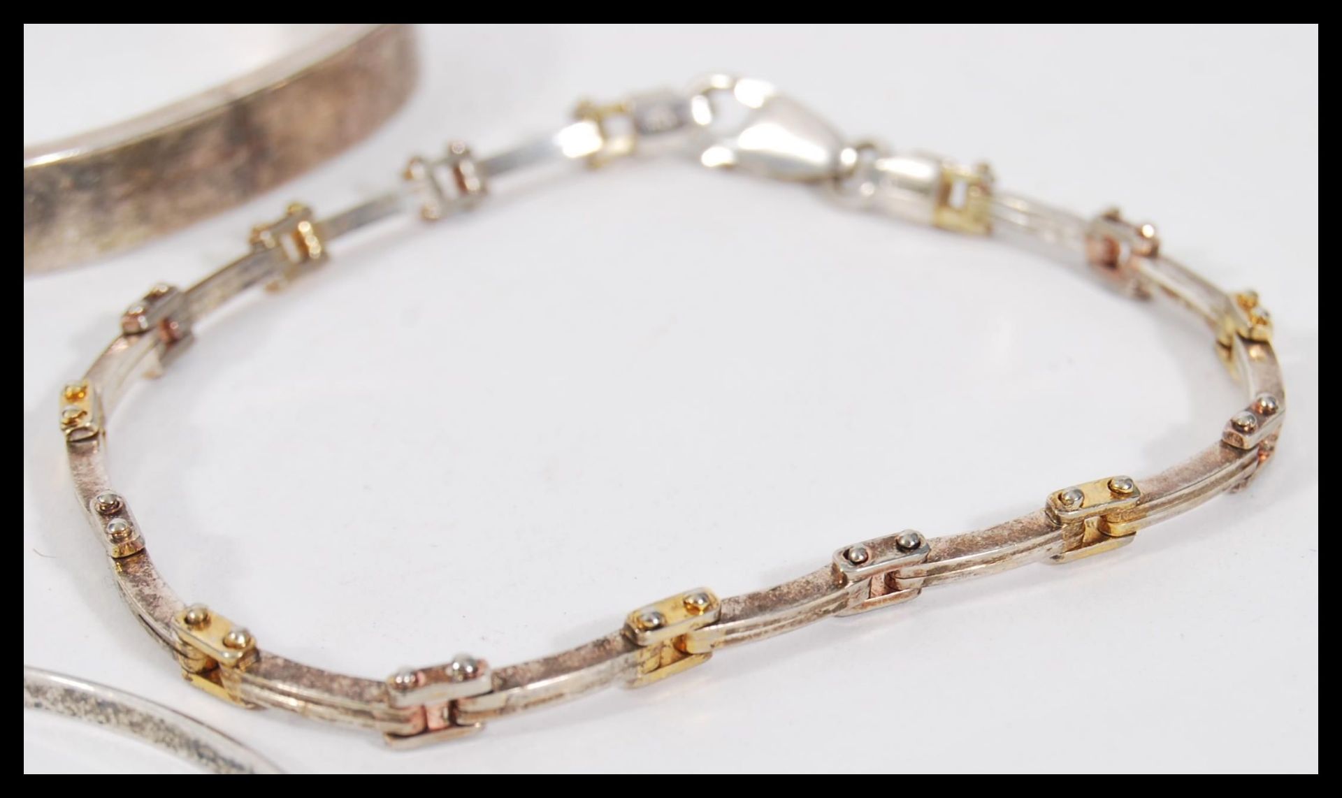 A selection of silver bracelets to include a square bangle with a hinge opening, a child's bangle - Image 3 of 5
