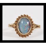 A vintage 20th Century hallmarked 9ct gold ring having a central opal panel in rope twist and bead