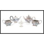 A group of silver plate to include a three piece tea service, additional teapot and silver plated