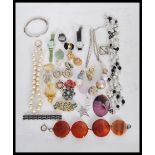 A collection of vintage costume jewellery to include a silver hinged bangle, a bracelet of four