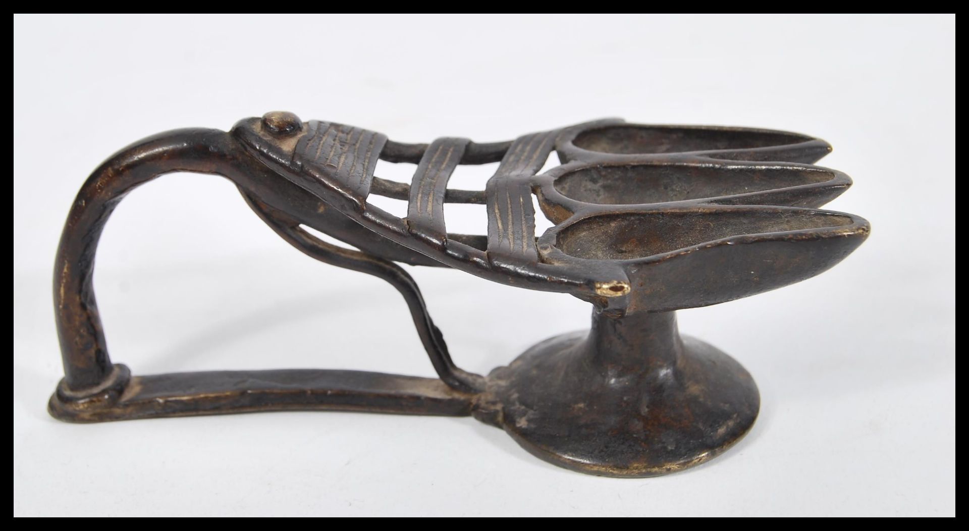An 18th Century Indian bronze triple oil offering lamp having three section end with shaped handle. - Image 2 of 4