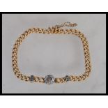 A 19th Century Victorian 18ct gold bracelet having a curb link chain with a central halo of old