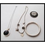 A selection of silver jewellery to include a stamped 925 silver bangle, a stamped 925 necklace of