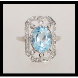 A stamped 925 silver panel ring set with a large oval cut topaz set with cz accent stones to the