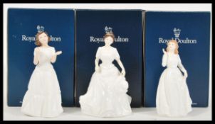Three Royal Doulton figurines of ladies in white dresses to include Harmony HN4096, Welcome HN3764