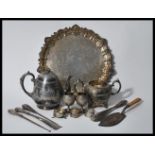 A collection of silverplate items to include a teapot having engraved foliate decoration and acorn