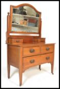 An early 20th Century Edwardian mahogany dressing table raised on tapering square legs with brass