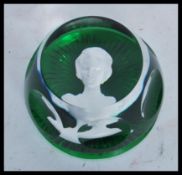 A vintage 20th Century Baccarat paperweight in green glass having a cameo portrait of a lady to