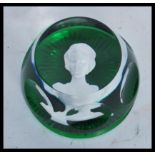 A vintage 20th Century Baccarat paperweight in green glass having a cameo portrait of a lady to