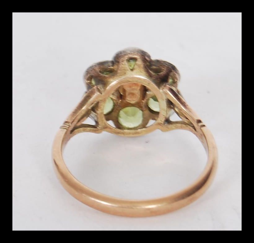 A stamped 9ct gold ring having a flower head seat with round cut peridots with a pearl to the - Image 3 of 4