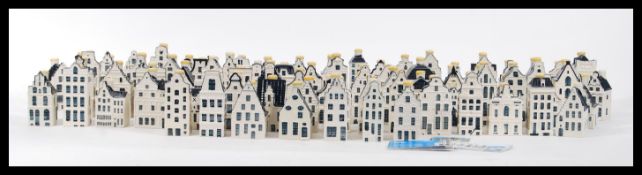 A collection of seventy nine collectable KLM ceramic blue and white Delft 'Bols' houses, all wax