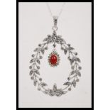 A stamped 925 silver necklace having a floral garland pendant set with marcasites and a coral