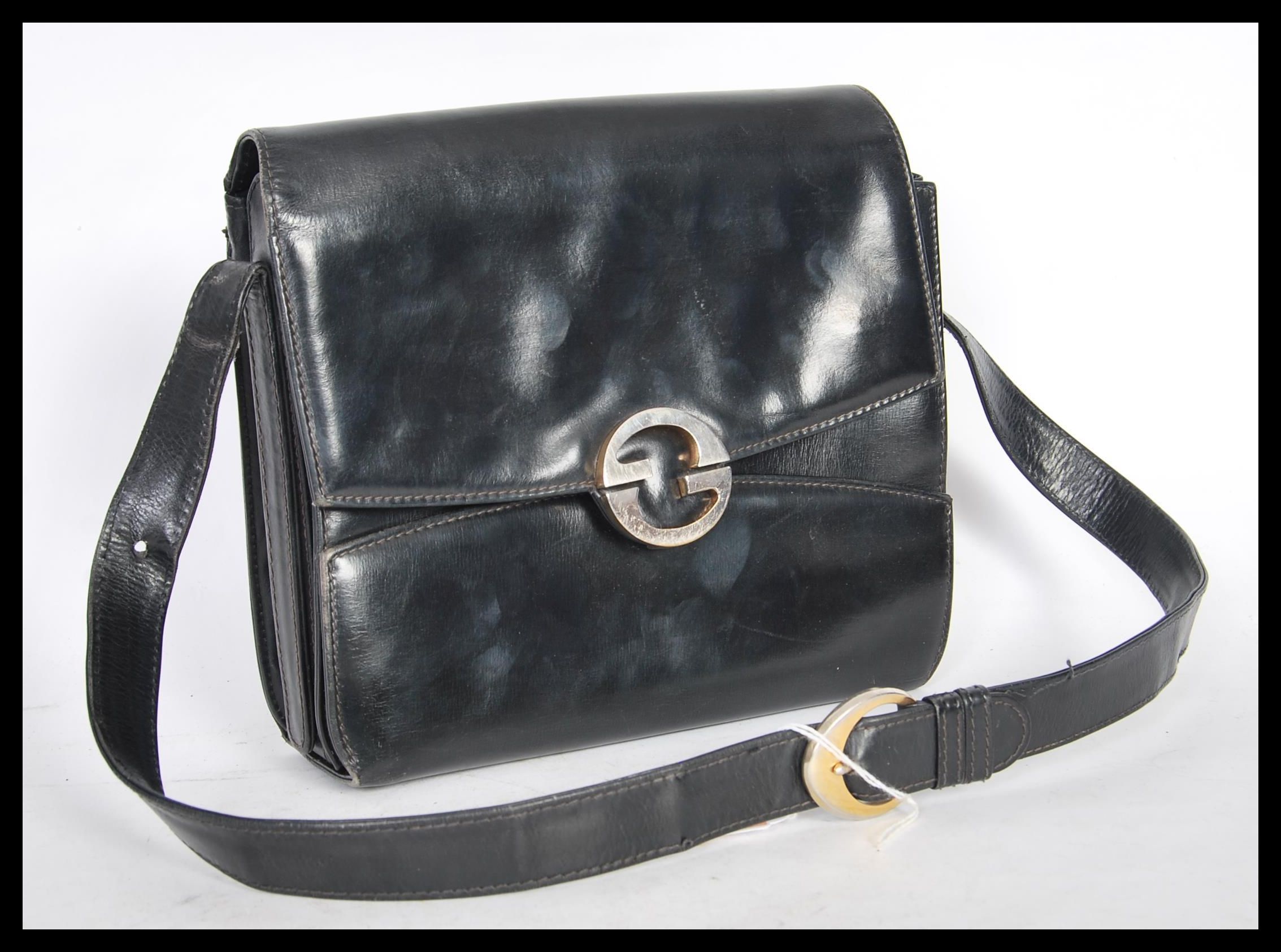 A 20th Century original designer Gucci black leather handbag with gilt metal interlocking G clasps