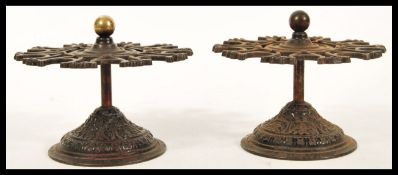 A pair of 19th Century Victorian cast metal stamp holders of circular form having shaped upper