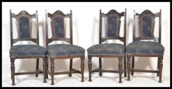 A set of four early 20th Century overstuffed Edwardian dining chairs, having blue fabric and