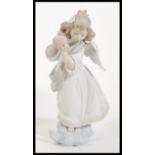 A Lladro ceramic figurine entitled ' Loving The World '  depicting an angel with flowers to hair