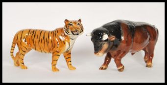 A large vintage 20th Century Beswick ceramic figurine in the form of a tiger along with a SylvaC