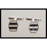 A pair of stamped 925 silver hexagonal cufflinks set with rows of cz's and sapphires. Weight 8.1g.