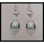 A pair of stamped 925 silver Art Deco style drop earrings set with cz accent stones, with opal