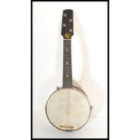 An early / mid 20th Century four string banjolele marked Pele, having an ebonised wood fretboard,