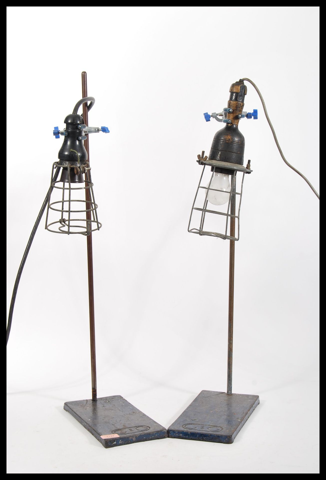 A pair of vintage retro 20th Century inspection lamps having wire cages mounted on Griffin and