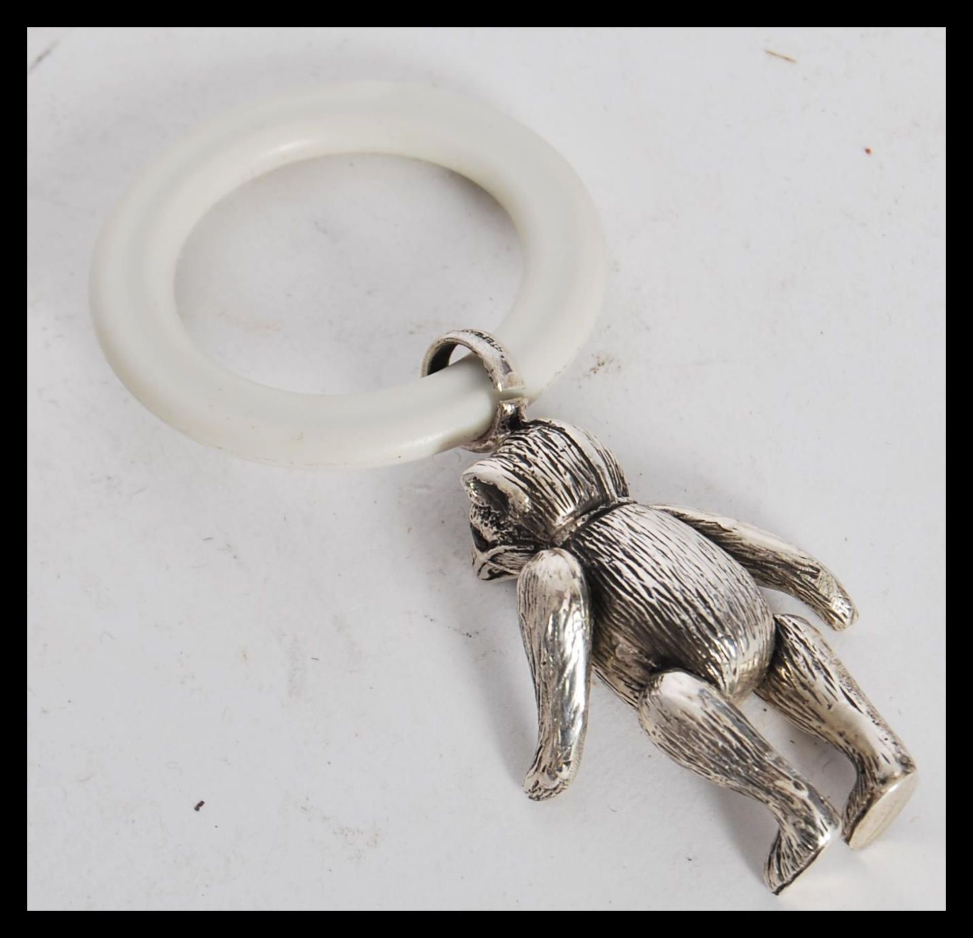 A sterling silver babies teething ring figurine in the form of a bear having articulated legs and - Bild 3 aus 3
