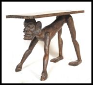 A 20th Century tribal art carved African hard wood side / coffee table having a rectangular top