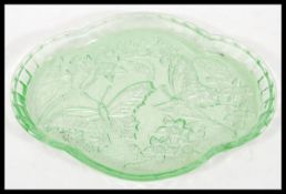 A vintage early 20th Century pressed Uranium glass dressing table set, the lidded dishes dish