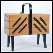 A vintage retro 20th Century beech wood work / sewing box with a concertina action, ebonised carry
