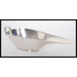 An early 20th Century hallmarked silver 1930's Art Deco elongated sauce boat / gravy jug by S