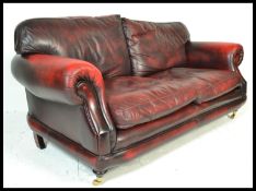 A good contemporary Thomas Lloyd, Chesterfield style three seater oxblood leather sofa, style
