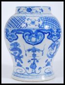 A 20th Chinese Chinese hand painted blue and white vase / jar depicting dragons and phoenix with
