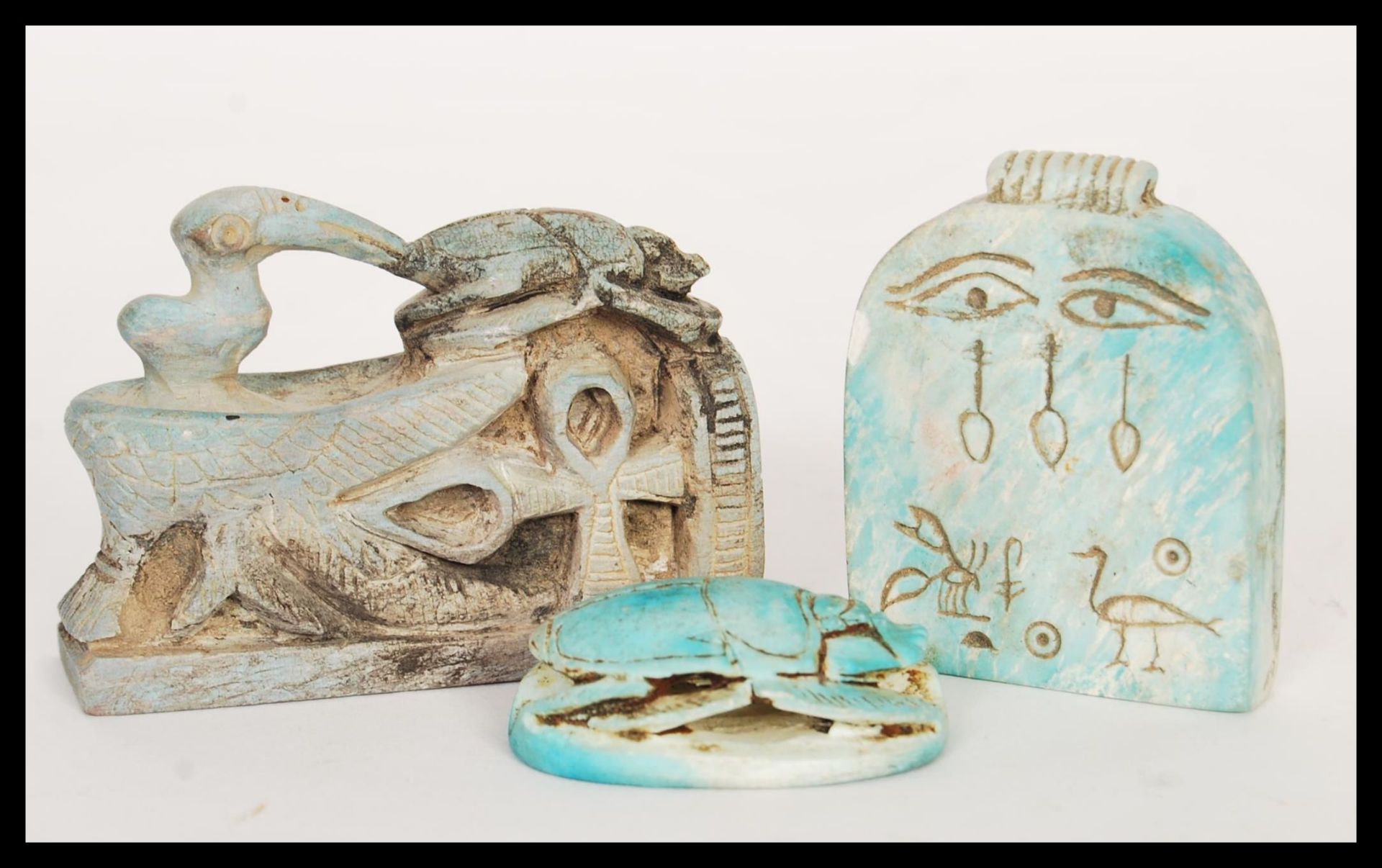 A group of 20th Century Egyptian revival amulets to include a ceramic scarab bead with hieroglyphics