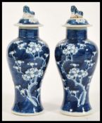 A pair of 19th Century Chinese blue and white porcelain temple vases / jars of bottle form having