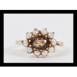 An early 20th Century hallmarked 9ct gold citrine and seed pearl ring having a central faceted