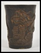 A 19th Century Chinese bronze miniature vase or cup / brush pot having relief decoration depicting