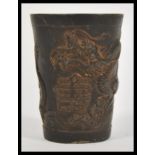 A 19th Century Chinese bronze miniature vase or cup / brush pot having relief decoration depicting