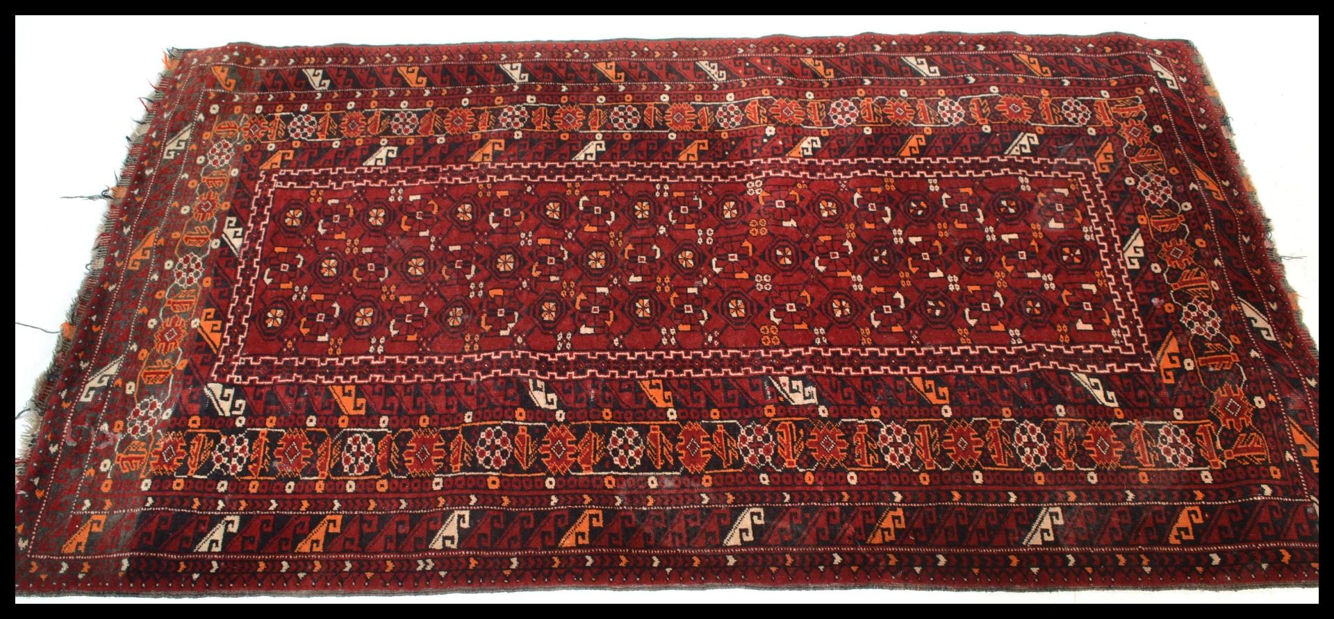 An early 20th Century Persian Islamic Middle Eastern runner carpet rug having a red ground with