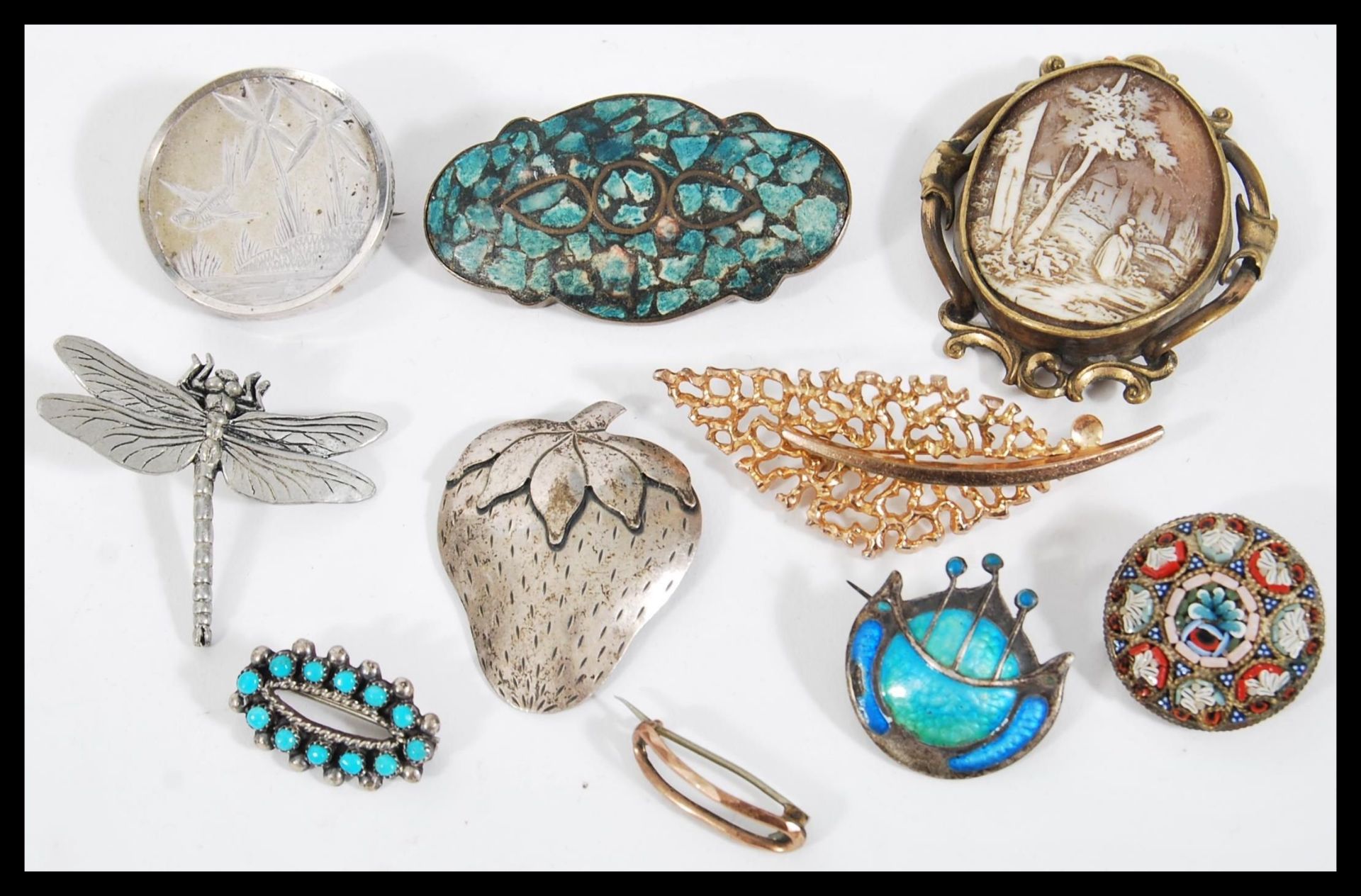 A collection of vintage 20th Century brooches to include a micro mosaic, cameo carved,silver, silver