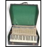 A vintage retro 20th Century large piano accordion by Itala having mother of pearl decoration with