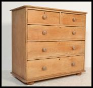 A 19th Century Victorian pitch pine chest of drawers. The bank of two over three drawers raised on