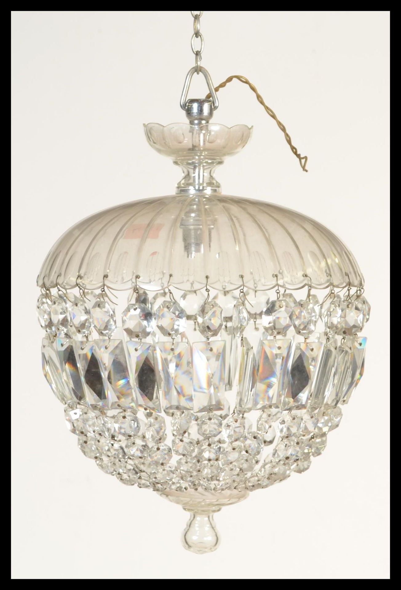 An early 20th Century large glass crystal chandelier hanging light fixture having multiple strands