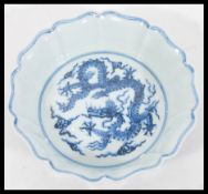 A 20th Century Chinese porcelain bowl of scalloped form having hand painted blue and white