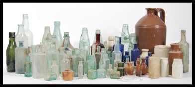 A collection of 19th Century bottles to include blue glass poison bottles, a Pinks ginger beer