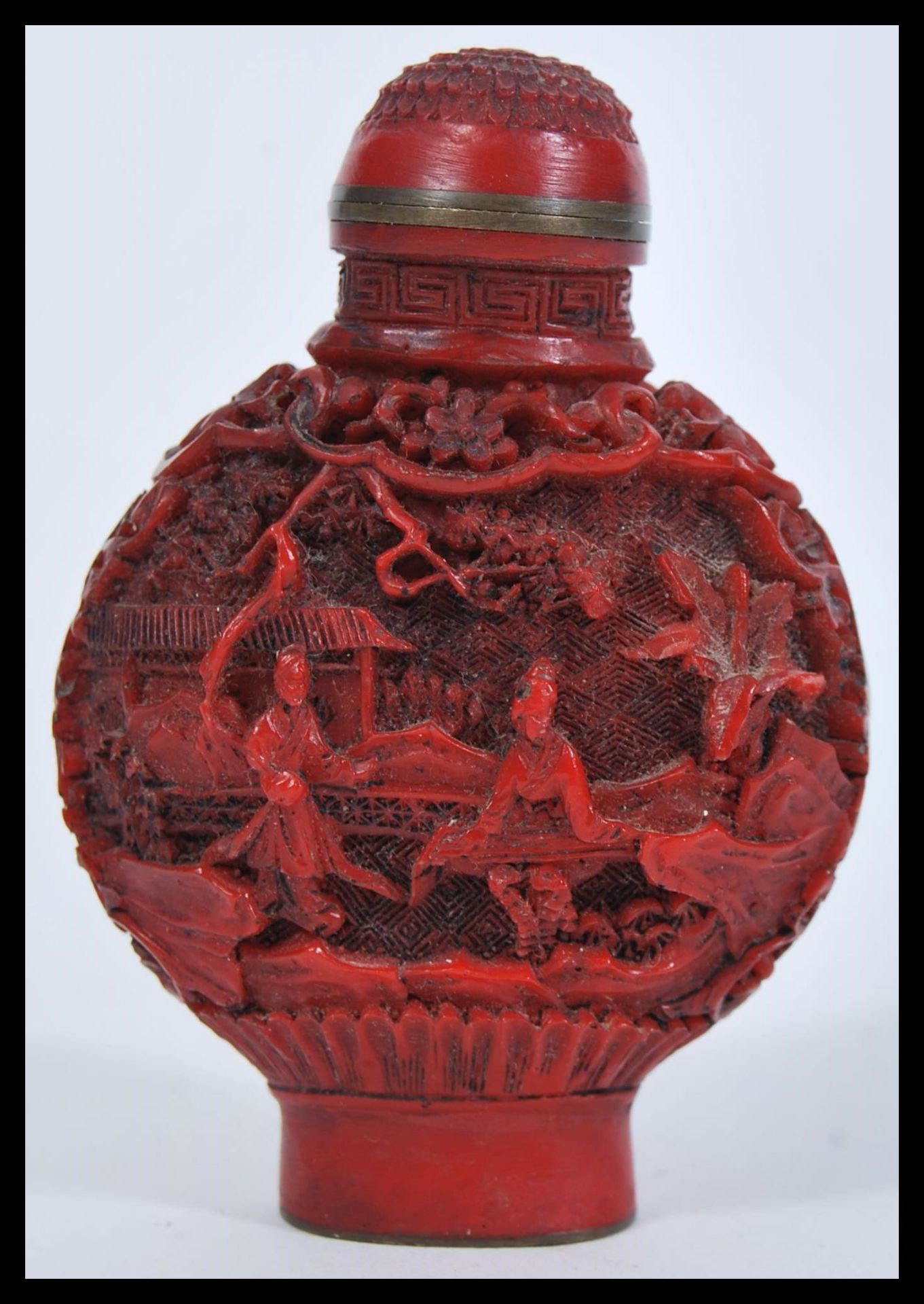 A 19th Century Chinese Cinnabar lacquer snuff bottle of moon flask shape having decoration depicting