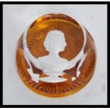 A vintage 20th Century Baccarat paperweight in amber glass having a cameo portrait of a lady to