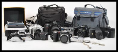A collection of vintage cameras lenses and accessories to include Nikon, boxed Olympus camera, Nikon