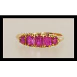 An early 20th Century 18ct gold ring prong set with five rectangular cut pink stones. Unmarked but